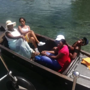 holiday-family-boat-rides-four-people-durban A family of four starting their Zulumoon canal cruise, one of the best value family boat rides in Durban.