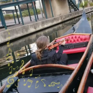 A violinist plays beautiful melodies from a second boat to soundtrack your private gondola boat rides along the Durban Point Waterfront.