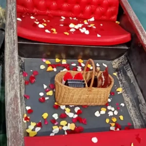 A picnic basket and colorful rose petals decorate a private gondola boat ride along the Durban Point Waterfront.