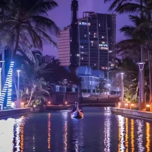 A romantic boat ride at night along the illuminated Point Waterfront canals.