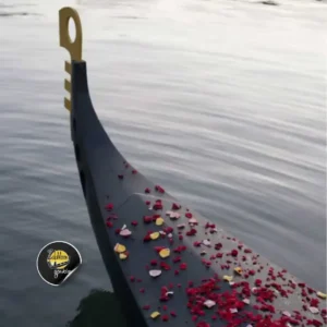 Rose petals scatter across the bow of a Zulumoon gondola boat during a flawless engagement cruise.