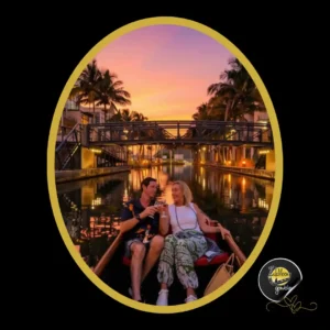 A happy couple toasts glasses on a boat ride, highlighting the best affordable romantic dates in Durban along the Point Waterfront canals.
