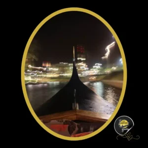 The front bow of a gondola cuts glides along illuminated canals on a fun date night boat ride.